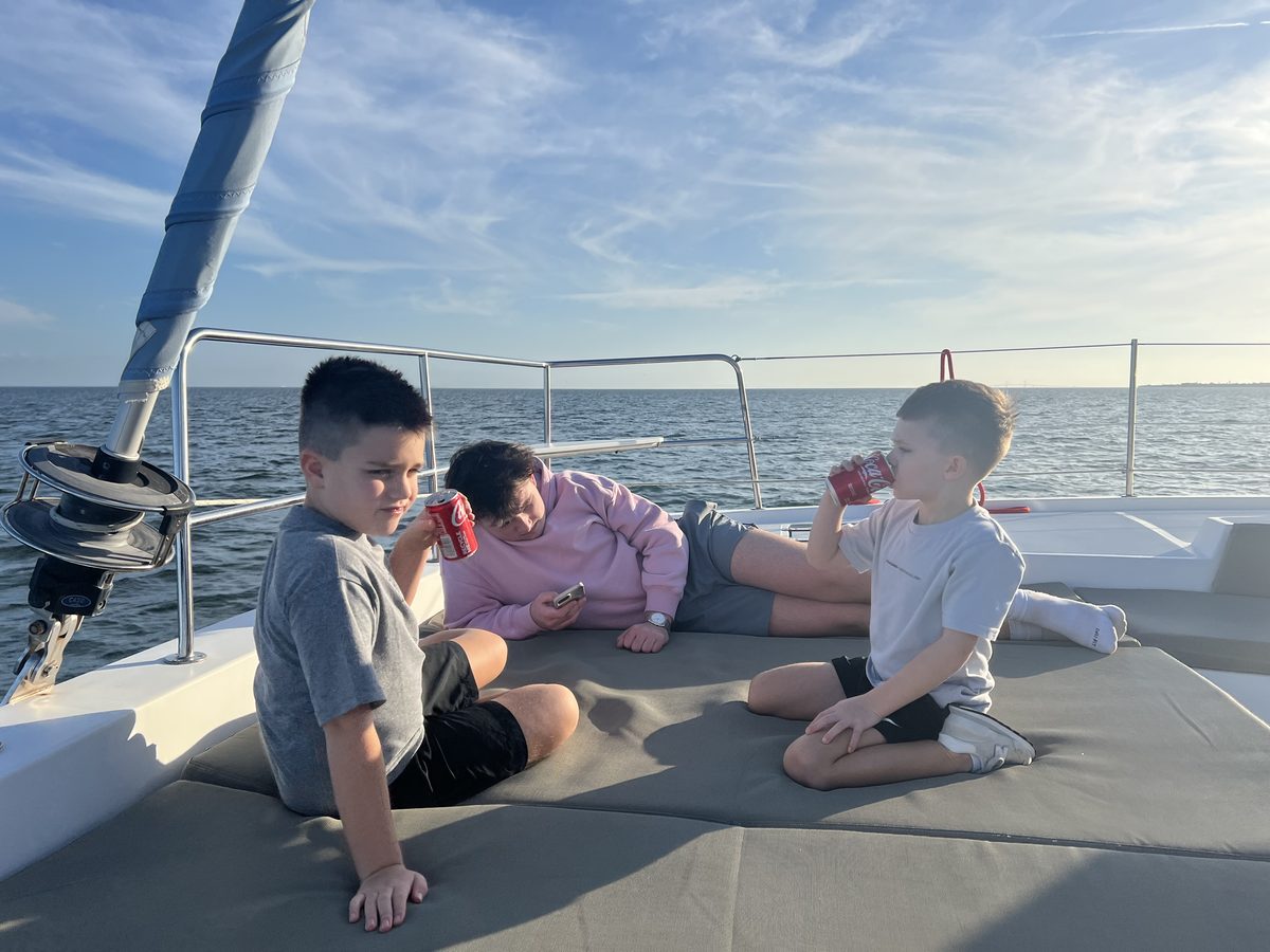 Kids hanging out on a boat on the water